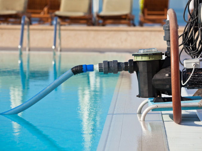 pool vacuum onb the side of a private swimming pool